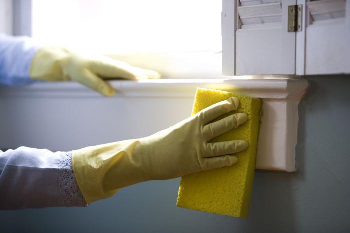 Sponge cleaning window sill with green cleaning technique