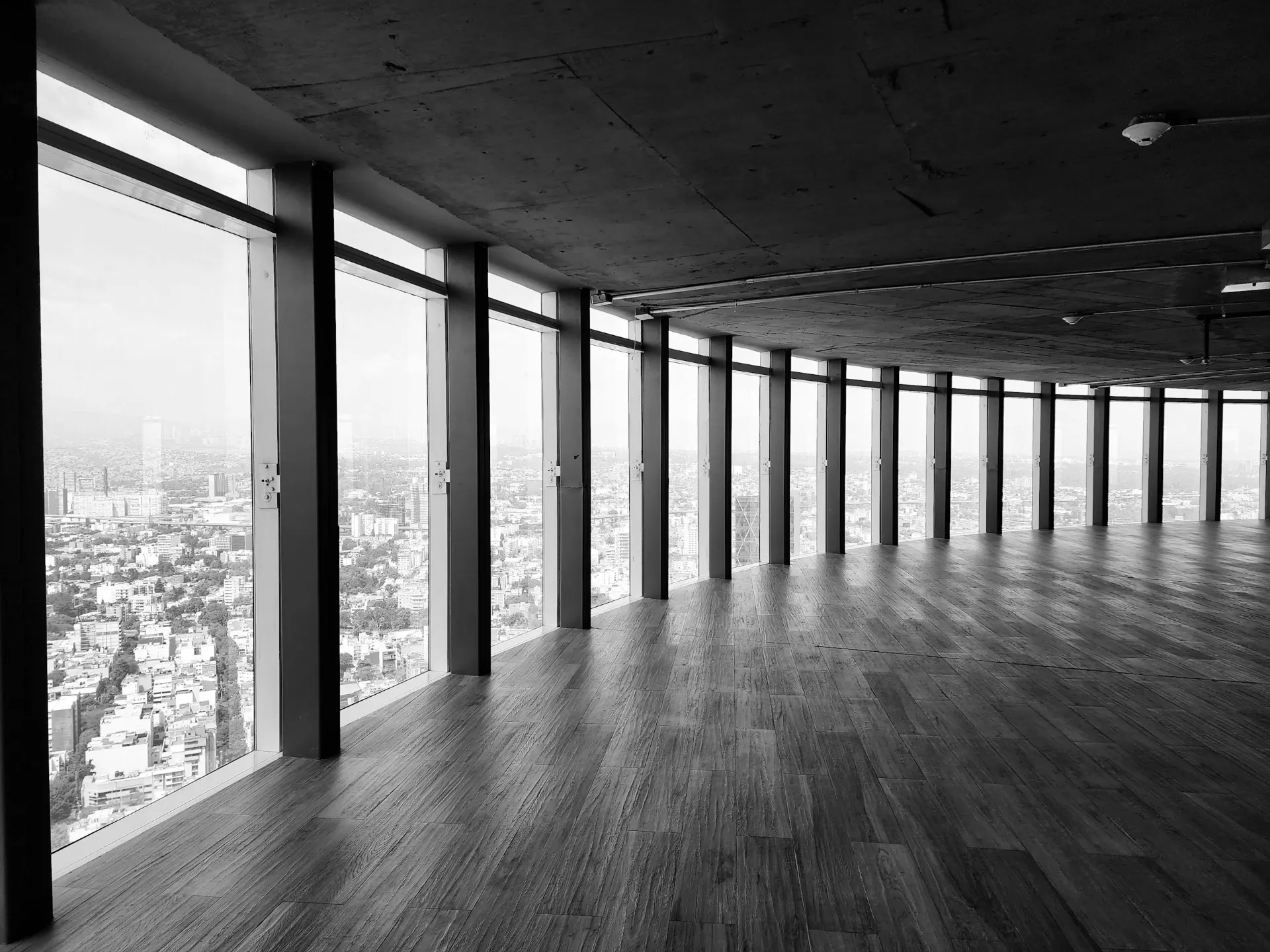 Empty open-plan office with floor-to-ceiling windows overlooking the city